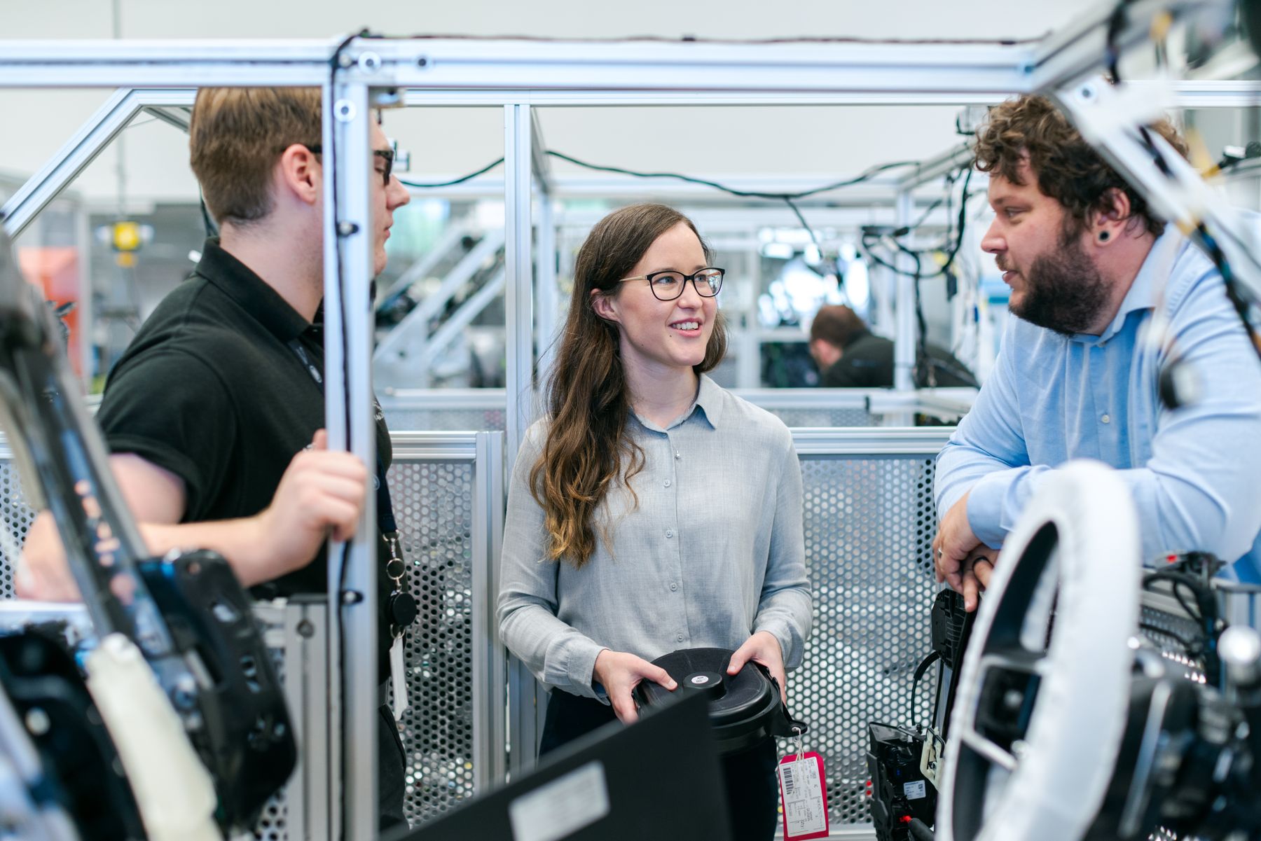 Engineers discussing work in a workshop, stock photograph
